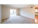 Bright living room with neutral carpeting and a large window overlooking the backyard, creating a serene space at 1800 Clairmont Lk # A719, Decatur, GA 30033
