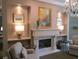 Cozy living room featuring a fireplace, decorative lamps, neutral paint, and a decorative chandelier at 1800 Clairmont Lk # A719, Decatur, GA 30033