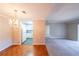 Inviting living room with beautiful hardwood floors and chandelier, leading into an open-concept kitchen with white appliances at 1800 Clairmont Lk # A719, Decatur, GA 30033