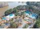 Aerial view of the pool, tennis courts, clubhouse, and lake in the community at 2542 Ashridge Ct, Lawrenceville, GA 30043