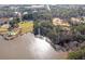 Aerial view of lake with shoreline and surrounding nature landscape at 2542 Ashridge Ct, Lawrenceville, GA 30043