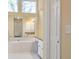 Bright bathroom featuring a soaking tub, granite countertop, and large windows at 2542 Ashridge Ct, Lawrenceville, GA 30043