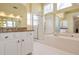Bathroom with soaking tub, shower, granite countertops, and ample natural light at 2542 Ashridge Ct, Lawrenceville, GA 30043