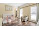 Bright Bedroom with a crib, hardwood floors, and a chair at 2542 Ashridge Ct, Lawrenceville, GA 30043