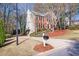 Charming brick home featuring a well-manicured lawn and a driveway leading to an attached garage at 2542 Ashridge Ct, Lawrenceville, GA 30043