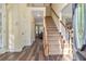 Inviting foyer featuring hardwood floors, a staircase, and a view into the dining room at 2542 Ashridge Ct, Lawrenceville, GA 30043