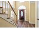 Bright foyer featuring hardwood floors, a staircase, and front door with sidelights at 2542 Ashridge Ct, Lawrenceville, GA 30043