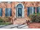 Elegant front door with arched transom window and brick steps at 2542 Ashridge Ct, Lawrenceville, GA 30043