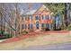 Charming brick two-story home featuring a well-manicured lawn and a classic front door with sidelights at 2542 Ashridge Ct, Lawrenceville, GA 30043