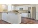 Kitchen with stainless steel refrigerator, white cabinets, and granite countertops at 2542 Ashridge Ct, Lawrenceville, GA 30043