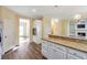 Kitchen with granite countertops, stainless oven, wood floors and pendant lights at 2542 Ashridge Ct, Lawrenceville, GA 30043