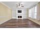 Living room featuring fireplace, built-in shelves, wood floors and neutral colors at 2542 Ashridge Ct, Lawrenceville, GA 30043