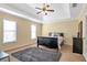 Main bedroom suite featuring a tray ceiling and a gray rug at 2542 Ashridge Ct, Lawrenceville, GA 30043