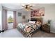 This cozy bedroom features a bed with a unique patterned duvet, complemented by matching curtains and a ceiling fan at 3628 Silvery Way, Powder Springs, GA 30127