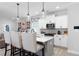 Bright kitchen features a quartz island, pendant lighting, stainless appliances, and white cabinetry at 3628 Silvery Way, Powder Springs, GA 30127