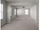 Large living room with carpet flooring, ceiling fan, and natural light from the multiple windows at 738 Basswood Ave, Mcdonough, GA 30252