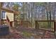 View of a rustic wooden back deck overlooking a wooded backyard at 2895 Wildflower Ln, Snellville, GA 30039