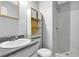Bathroom featuring a white shower, toilet and vanity with modern fixtures and ample shelving at 2895 Wildflower Ln, Snellville, GA 30039