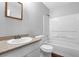 Bright bathroom showcasing a tub and shower combo, gray walls and a sink at 2895 Wildflower Ln, Snellville, GA 30039