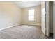 Clean bedroom with a large window and neutral carpet, offering a comfortable and relaxing space at 2895 Wildflower Ln, Snellville, GA 30039