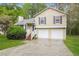 Split-level home with a large driveway and manicured lawn, offering curb appeal and convenience at 2895 Wildflower Ln, Snellville, GA 30039