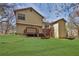 A charming two-story home's exterior with a deck and a spacious lawn at 2895 Wildflower Ln, Snellville, GA 30039