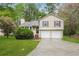Split-level home with a large driveway and manicured lawn, offering curb appeal and convenience at 2895 Wildflower Ln, Snellville, GA 30039