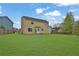 Expansive backyard featuring lush green lawn and a two-story home, ideal for outdoor activities and relaxation at 864 Oakhill Ct, Stone Mountain, GA 30088