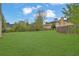 Expansive backyard featuring a lush green lawn with mature trees, offering a peaceful retreat and space for outdoor activities at 864 Oakhill Ct, Stone Mountain, GA 30088