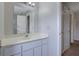 Bright bathroom featuring a single sink vanity and a mirror at 864 Oakhill Ct, Stone Mountain, GA 30088