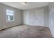 Spacious bedroom with a window and neutral walls, providing a blank canvas for personalization and comfortable living at 864 Oakhill Ct, Stone Mountain, GA 30088