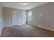 Bright bedroom with a window and neutral walls, providing a blank canvas for personalization and comfortable living at 864 Oakhill Ct, Stone Mountain, GA 30088