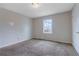 Bedroom with neutral walls and carpeting, featuring a window for natural light at 864 Oakhill Ct, Stone Mountain, GA 30088