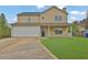 Inviting two-story home with a well-manicured lawn, front porch, and attached two-car garage at 864 Oakhill Ct, Stone Mountain, GA 30088