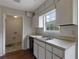 Practical kitchen with essential appliances, a window, and a doorway to a laundry area at 864 Oakhill Ct, Stone Mountain, GA 30088