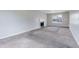 Spacious living room featuring a fireplace, large window, and neutral carpet flooring at 864 Oakhill Ct, Stone Mountain, GA 30088