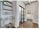 Hallway featuring a modern shelving unit and a view into the updated bathroom at 878 Peachtree Ne St # 535, Atlanta, GA 30309