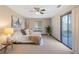 Cozy bedroom featuring neutral carpeting, a sliding glass door, and lots of natural light at 4062 Wildflower Ln, Tucker, GA 30084