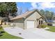 Exterior view of home with a two car garage and well manicured lawn at 4062 Wildflower Ln, Tucker, GA 30084