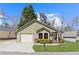 Charming single-story home featuring manicured lawn, attached garage and inviting front entrance with a decorative wreath at 4062 Wildflower Ln, Tucker, GA 30084