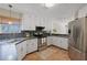 Bright kitchen features white cabinets, stainless steel appliances, and stone countertops with a tiled floor at 4062 Wildflower Ln, Tucker, GA 30084