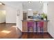 The kitchen has an eat-in bar with chairs, white cabinets, stainless appliances and plenty of counter space at 4062 Wildflower Ln, Tucker, GA 30084