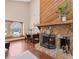 Bright living room featuring hardwood floors, a stone fireplace, large window, and a desk at 4062 Wildflower Ln, Tucker, GA 30084