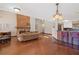 Bright living room with wood floors, stone fireplace, and an open layout leading to the kitchen and dining area at 4062 Wildflower Ln, Tucker, GA 30084
