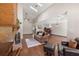 Cozy living room featuring a stone fireplace, hardwood floors, and plenty of natural light from skylights at 4062 Wildflower Ln, Tucker, GA 30084