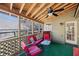 Outdoor screened porch with lounge furniture, ceiling fan, and wood beams creating an inviting space at 4062 Wildflower Ln, Tucker, GA 30084