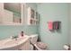 Traditional bathroom with light blue walls, a pedestal sink, and a classic mirror at 4113 Stutz Ct, Tucker, GA 30084