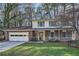 Charming brick two-story home with a front porch and attached garage at 4113 Stutz Ct, Tucker, GA 30084
