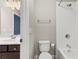 Well lit bathroom with toilet, vanity and shower at 2315 Monet Dr, Cumming, GA 30041