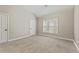 Spacious bedroom featuring neutral carpet, trim, and natural light at 2315 Monet Dr, Cumming, GA 30041